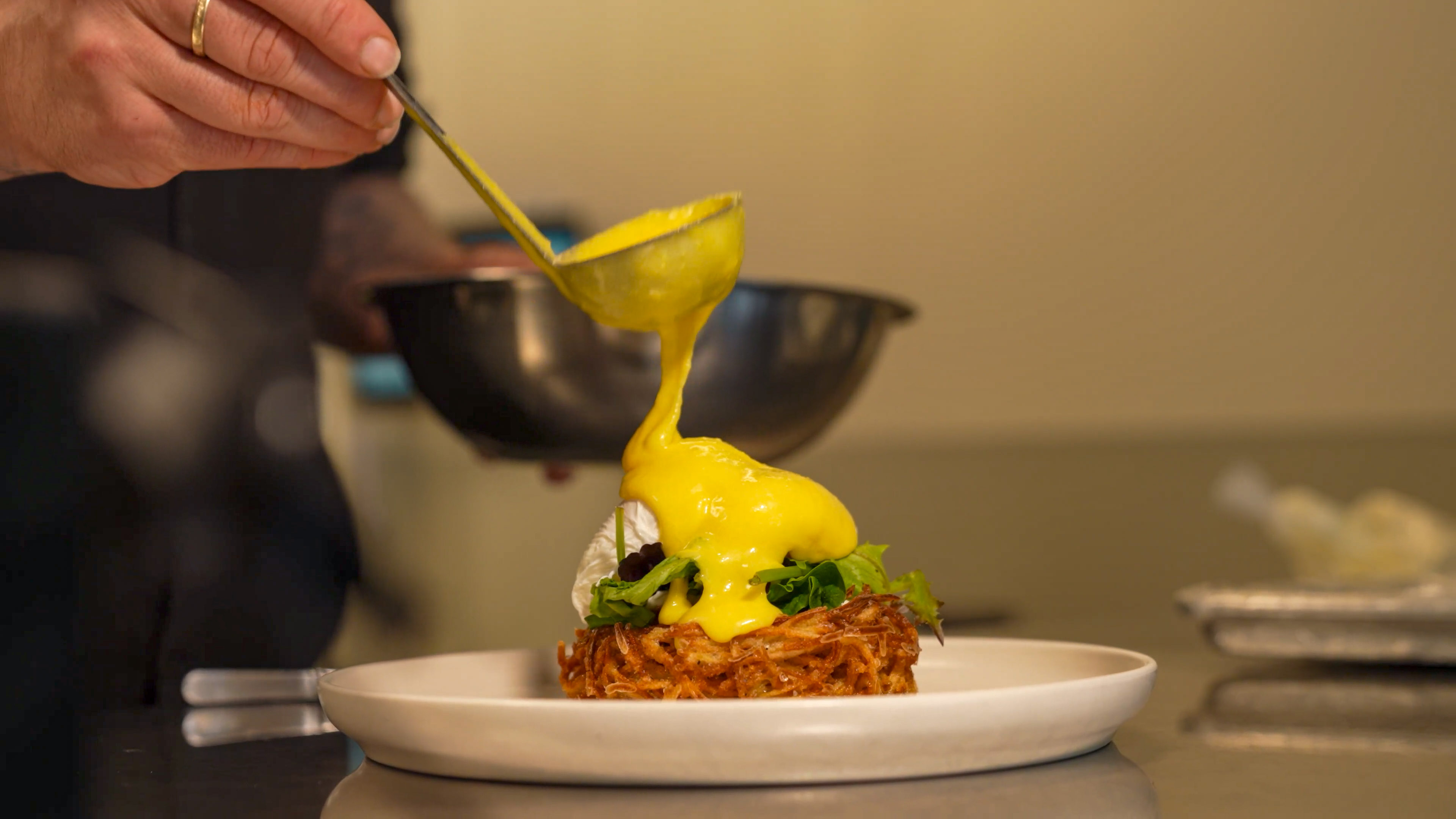 Hollandaise being poured in the Bar Torino kitchen