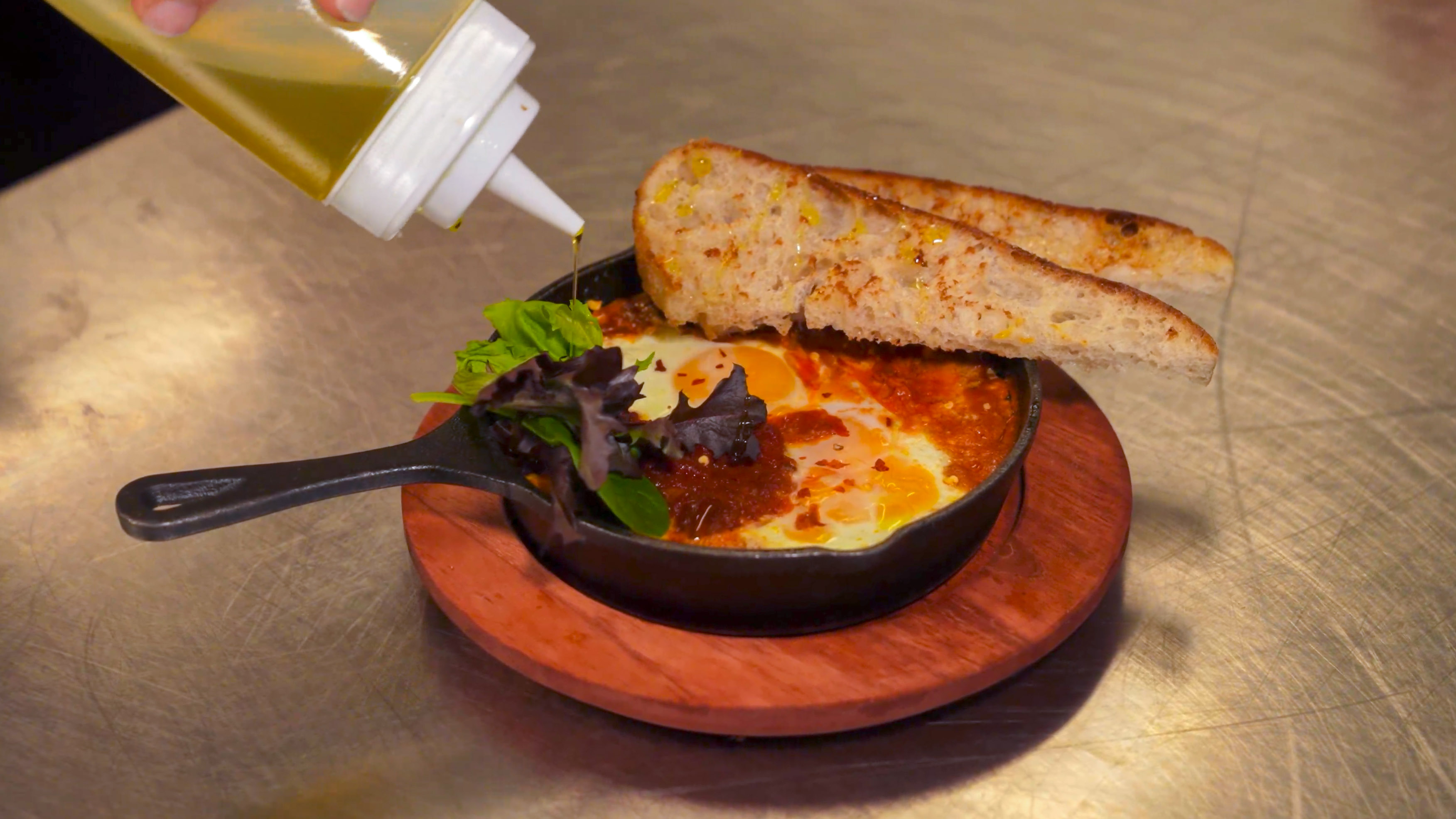 Skillet dish being finished in the Bar Torino kitchen
